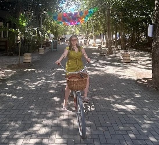 Woman riding a rental bike in Tulum, Mexico